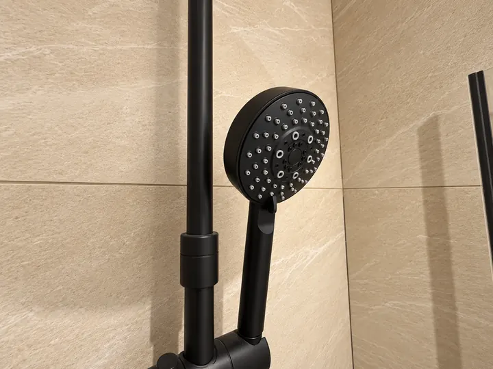 Douchette noire sur carrelage beige