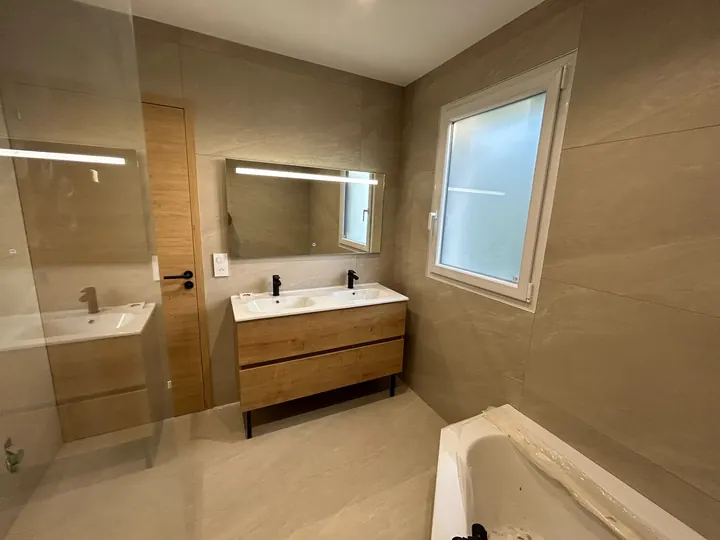 Salle de bains avec double vasque et fenêtre